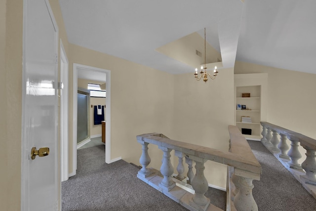 hall with built in features, visible vents, vaulted ceiling, carpet flooring, and a notable chandelier