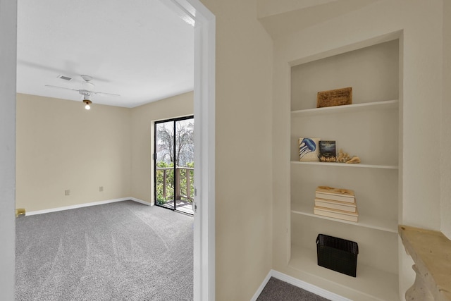 interior space featuring baseboards, carpet floors, and visible vents