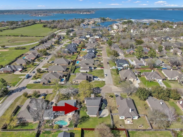 drone / aerial view featuring a residential view and a water view