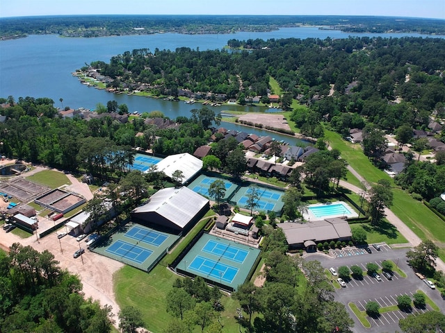 bird's eye view featuring a wooded view and a water view