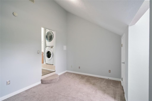 laundry room with laundry area, carpet flooring, baseboards, and stacked washer and dryer