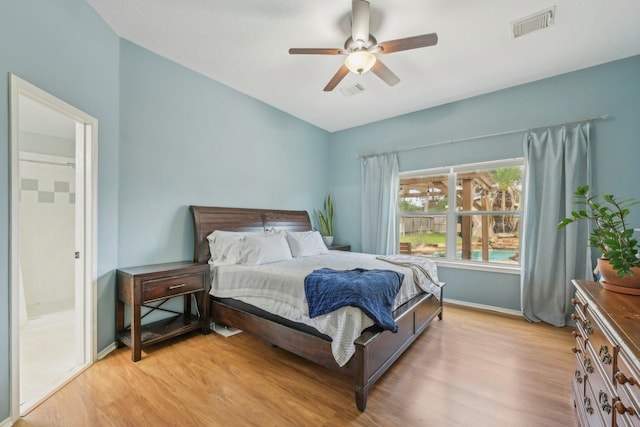 bedroom featuring visible vents, baseboards, light wood-style floors, and ceiling fan