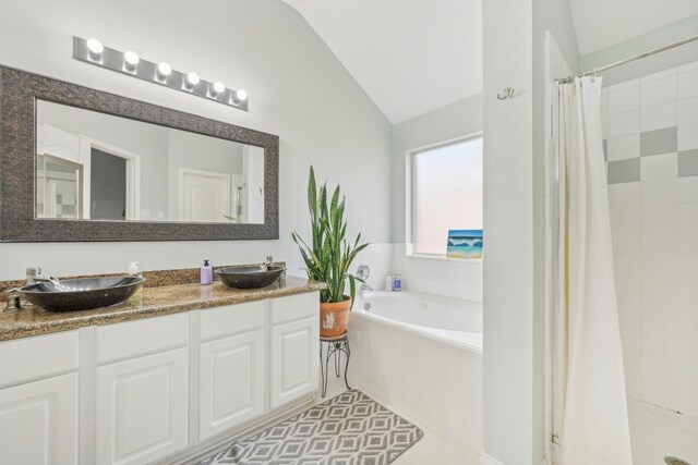 bathroom featuring a sink, a bath, a shower stall, and vaulted ceiling