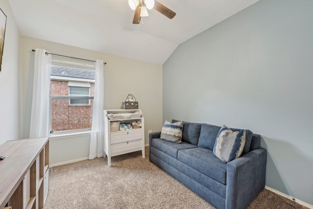 living area featuring baseboards, lofted ceiling, a ceiling fan, and carpet flooring