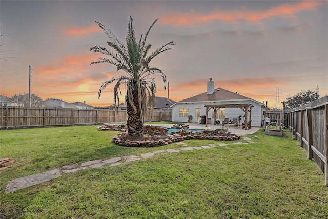 yard at dusk featuring a gazebo, a patio, a pergola, and a fenced backyard