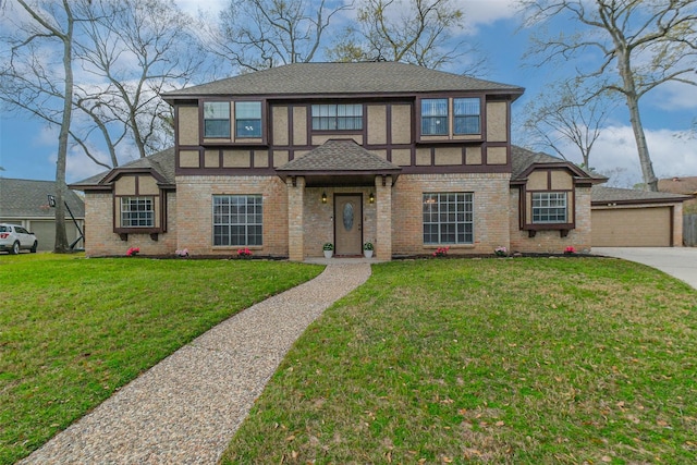 english style home with a front lawn, a garage, brick siding, and a shingled roof