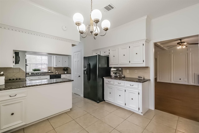 kitchen with dark stone countertops, light tile patterned floors, visible vents, white cabinets, and black fridge with ice dispenser