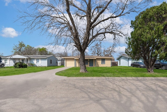 ranch-style house with a garage and a front yard