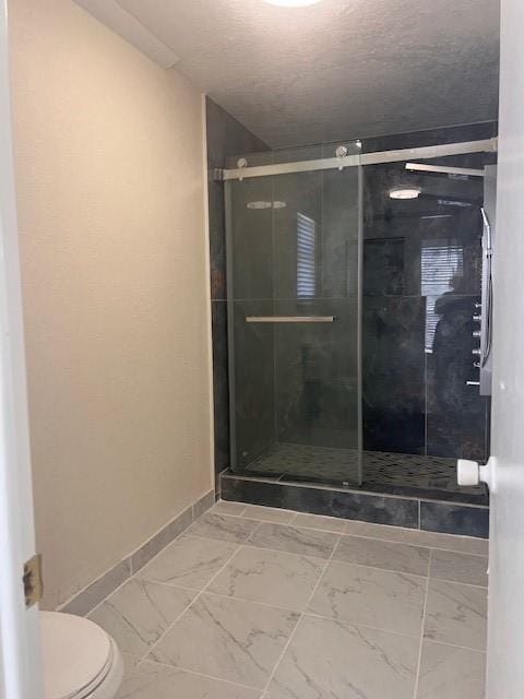 11603 Counselor St, Houston, TX 77065 - full bathroom with a stall shower, marble look tiles, and a textured ceiling