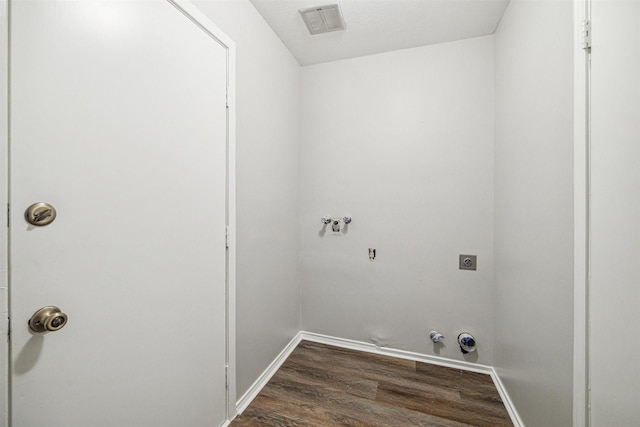 clothes washing area featuring dark wood-type flooring, gas dryer hookup, washer hookup, laundry area, and hookup for an electric dryer