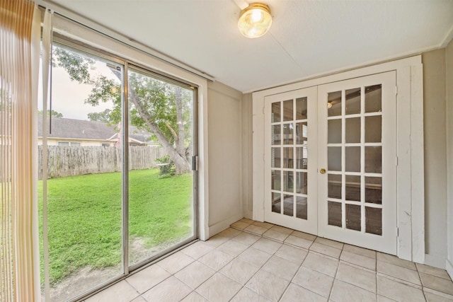 doorway to outside featuring tile patterned floors and french doors