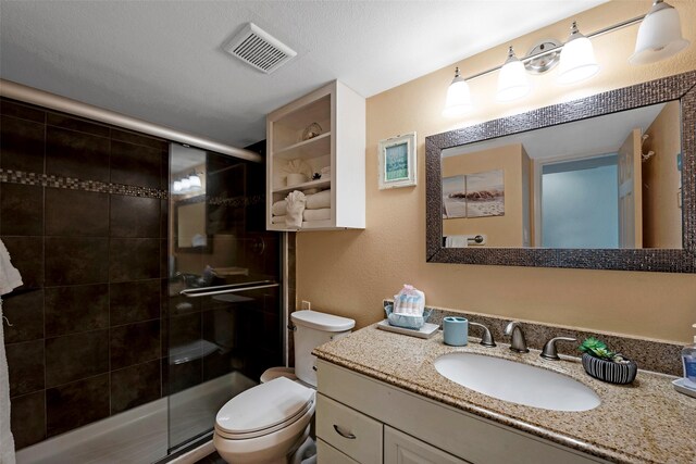 full bath featuring visible vents, toilet, a stall shower, and vanity