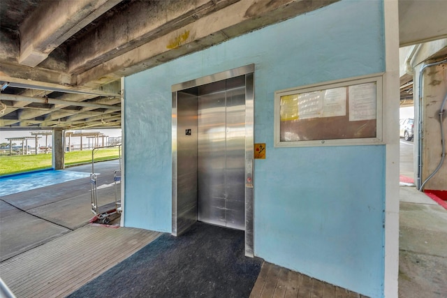 exterior space featuring elevator and stucco siding