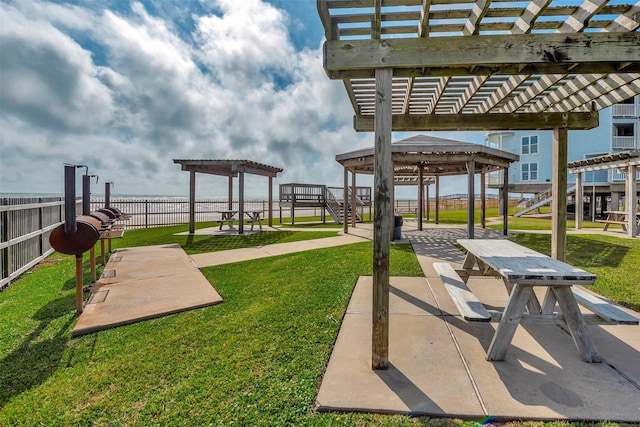 surrounding community featuring a pergola, a yard, and fence