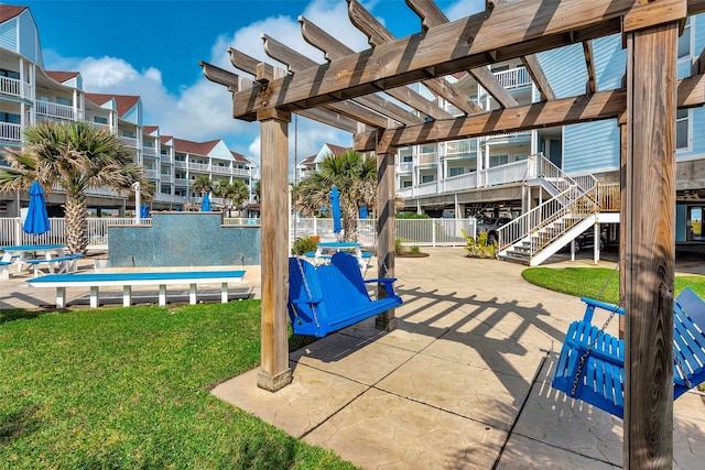 surrounding community with fence, stairs, a lawn, a patio area, and a pergola