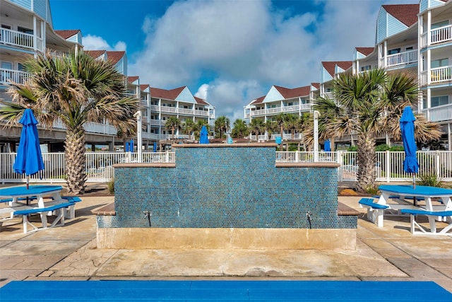 view of pool with a patio and fence