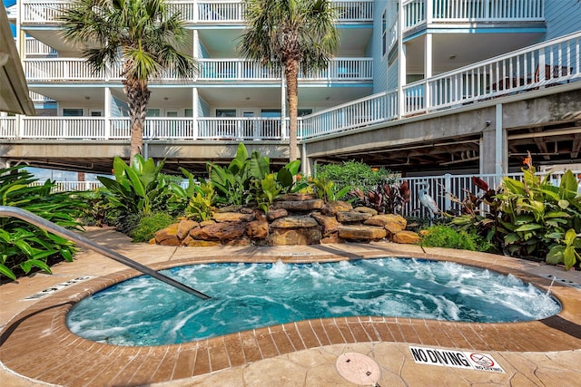 view of swimming pool featuring a community hot tub