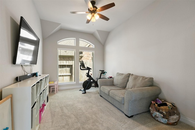 workout area with vaulted ceiling, a ceiling fan, and light carpet