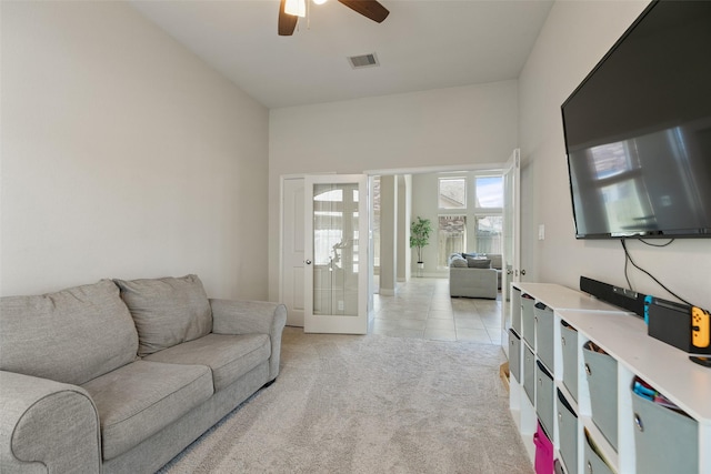 living room with french doors, light carpet, visible vents, and a ceiling fan