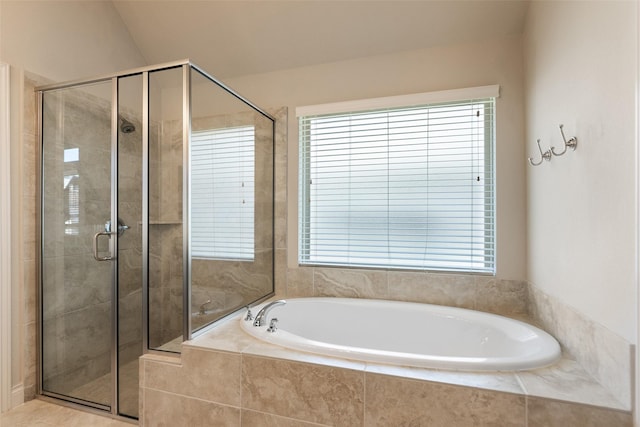 full bath with a stall shower and a garden tub