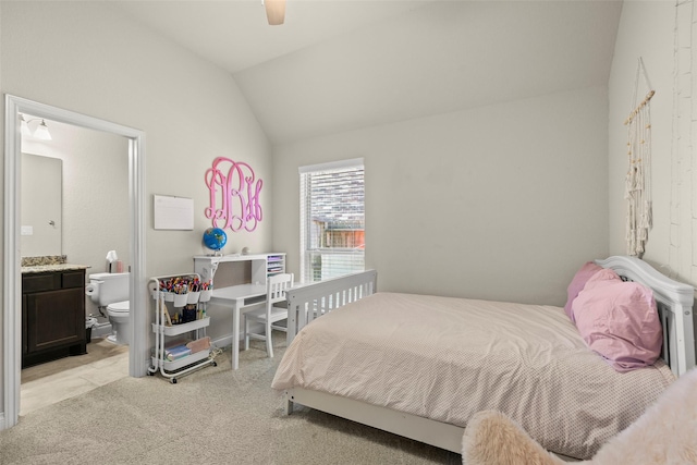 bedroom with connected bathroom, lofted ceiling, light colored carpet, and ceiling fan