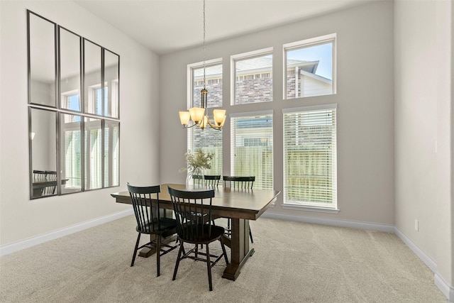 dining room featuring a notable chandelier, a healthy amount of sunlight, and carpet