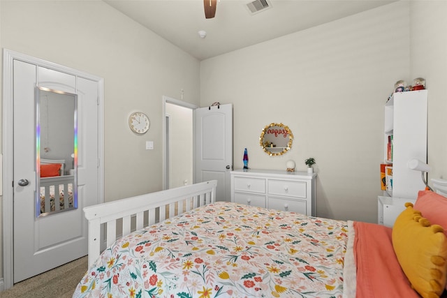 carpeted bedroom featuring visible vents and ceiling fan