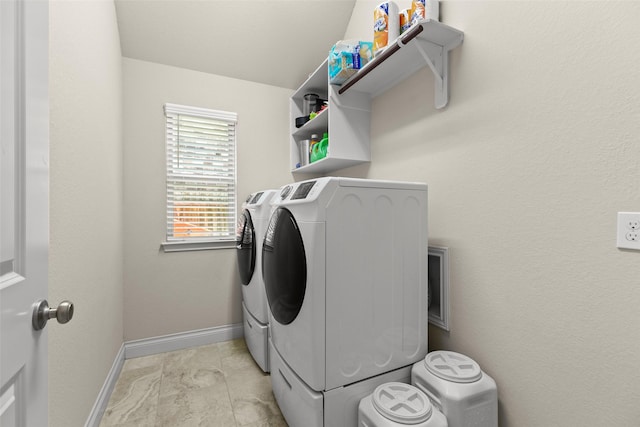 laundry area featuring laundry area, baseboards, and independent washer and dryer