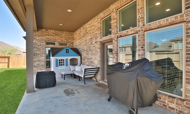 view of patio / terrace featuring area for grilling and fence