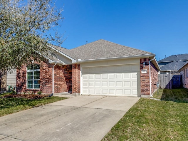 ranch-style house featuring a front yard, fence, driveway, a garage, and brick siding