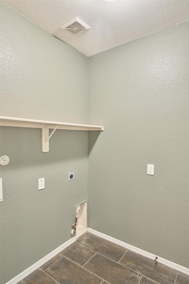 washroom featuring visible vents, baseboards, laundry area, hookup for a gas dryer, and electric dryer hookup