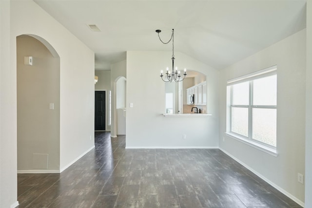 interior space with a notable chandelier, baseboards, dark wood-type flooring, and visible vents