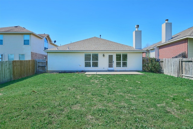 back of house featuring a fenced backyard, a lawn, and a patio