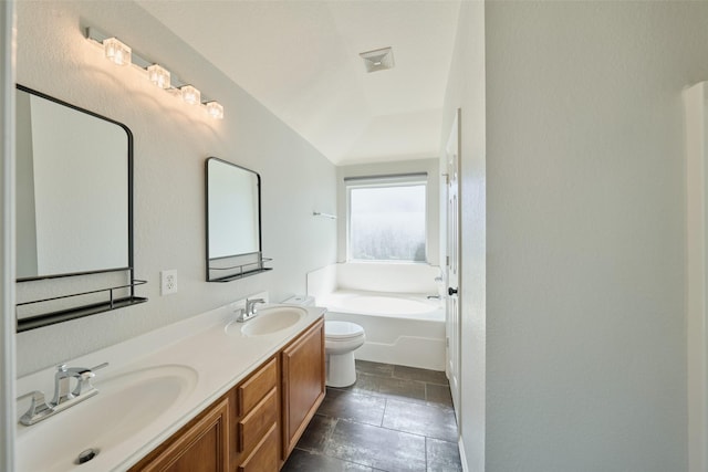 bathroom featuring double vanity, visible vents, a garden tub, and a sink