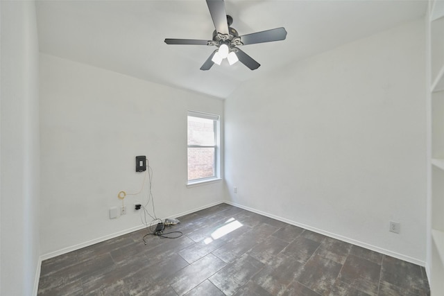 unfurnished room with vaulted ceiling, baseboards, and ceiling fan