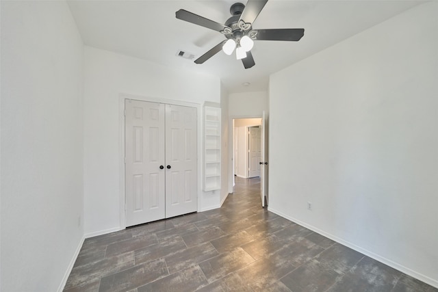 unfurnished bedroom with a ceiling fan, baseboards, visible vents, and a closet