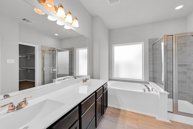 full bathroom with a sink, visible vents, a bath, and a shower stall