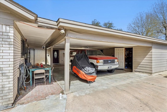 view of parking with an attached carport and driveway