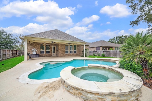 view of pool featuring a pool with connected hot tub, a fenced backyard, a ceiling fan, and a patio area