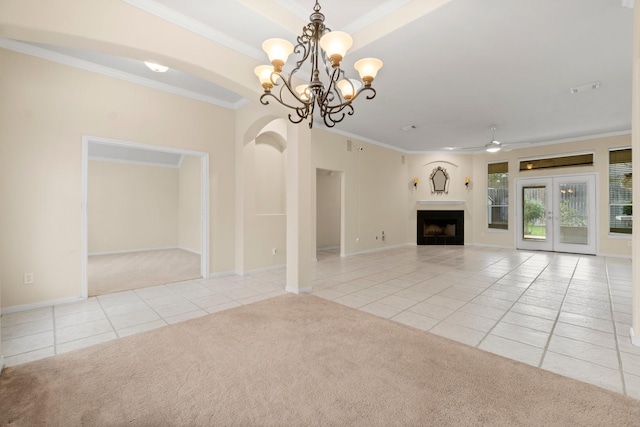 unfurnished living room with crown molding, carpet, ceiling fan with notable chandelier, a fireplace, and tile patterned floors