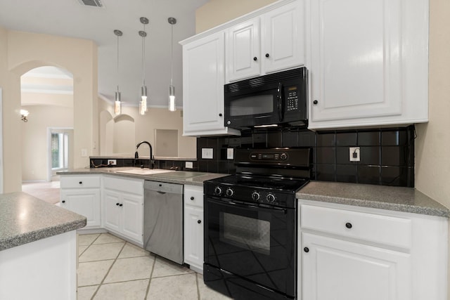 kitchen with tasteful backsplash, light tile patterned floors, arched walkways, and black appliances