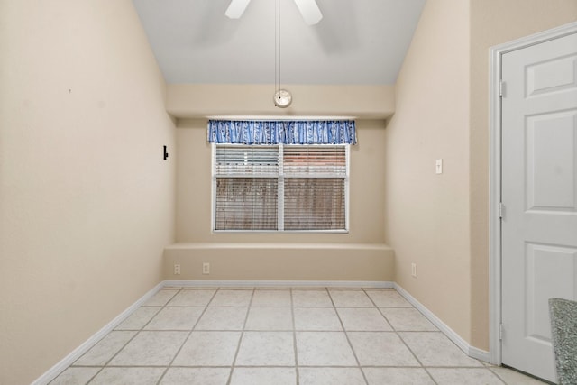 unfurnished dining area featuring light tile patterned flooring, baseboards, and ceiling fan