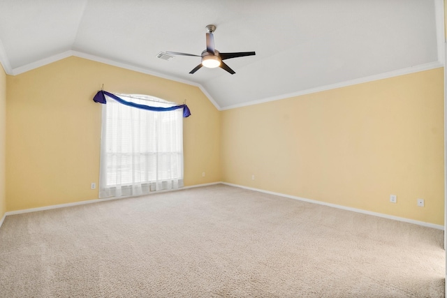 carpeted spare room featuring baseboards, lofted ceiling, ceiling fan, and crown molding