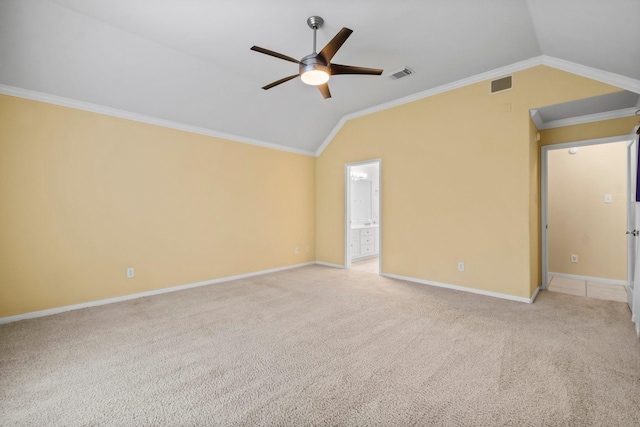 unfurnished room with visible vents, light colored carpet, crown molding, and vaulted ceiling