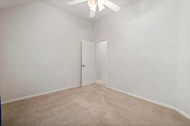 unfurnished room featuring high vaulted ceiling, light colored carpet, baseboards, and a ceiling fan