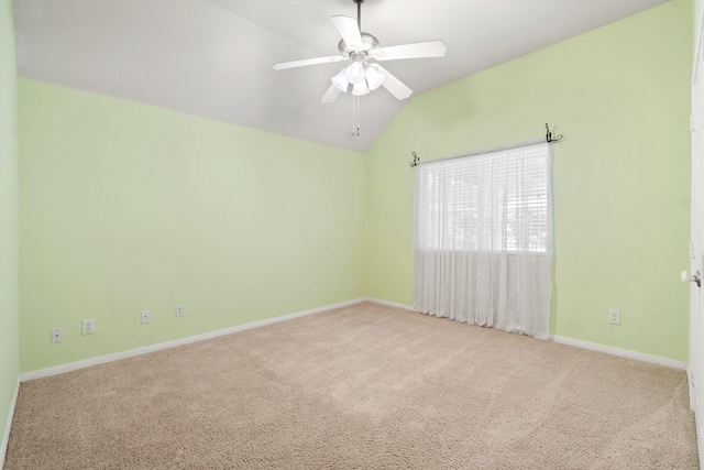 empty room with baseboards, carpet floors, lofted ceiling, and ceiling fan