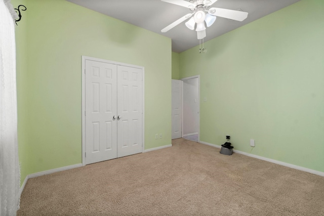 unfurnished bedroom with a closet, baseboards, carpet, and a ceiling fan