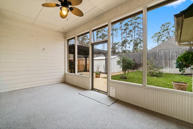 unfurnished sunroom featuring a wealth of natural light and ceiling fan