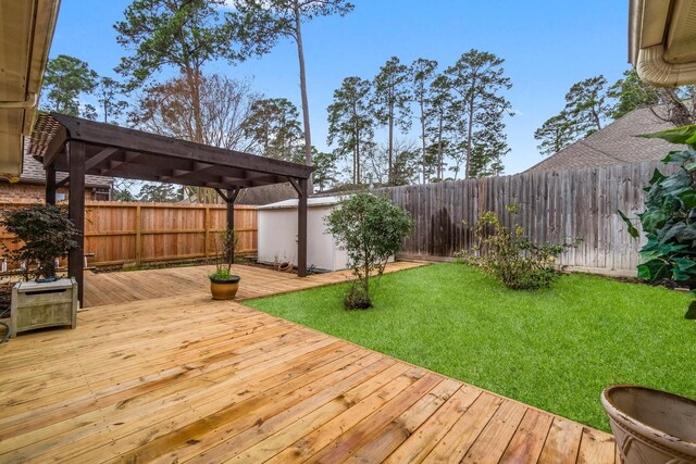 wooden deck with a lawn, a fenced backyard, and a pergola