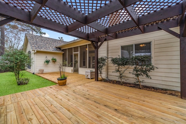 wooden deck with a pergola, a yard, and a sunroom